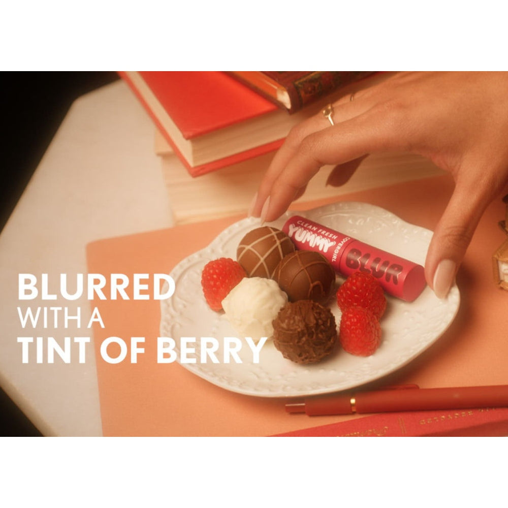 Model holding Covergirl Clean Fresh Yummy Blur with dessert on a plate. Blurred with a tint of berry.