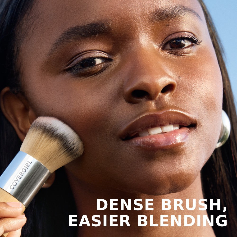 Model applying CoverGirl blending brush. Dense brush, easier blending.