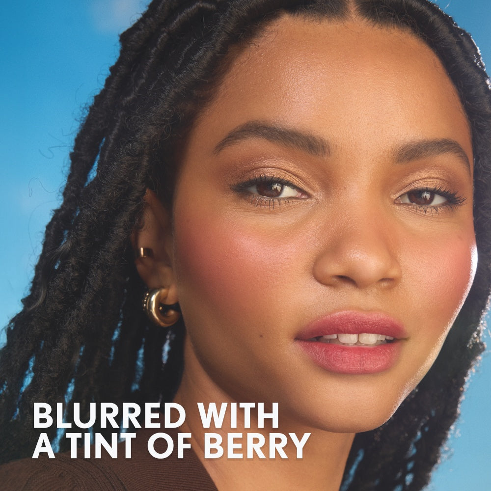 Model with a blurred complexion and a tint of berry on the lips.
