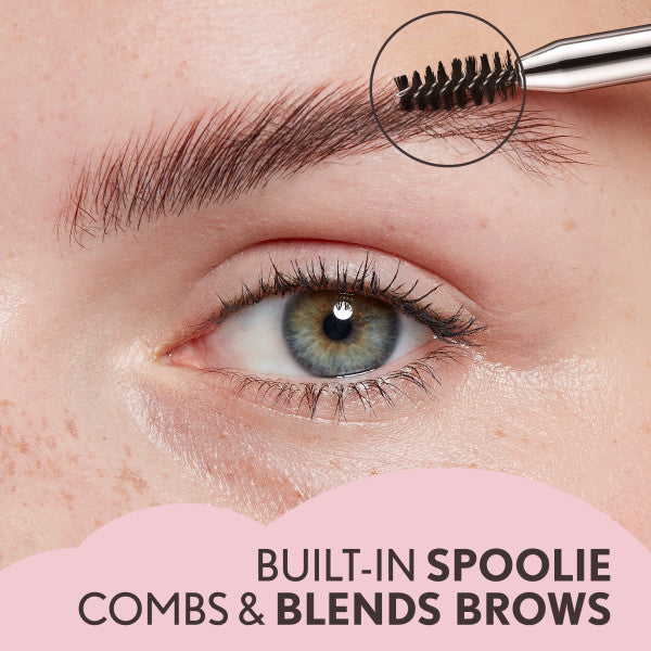 Model using Clean Fresh Brow Volumizer Fiber Powder Pencil with built-in spoolie for blending brows.
