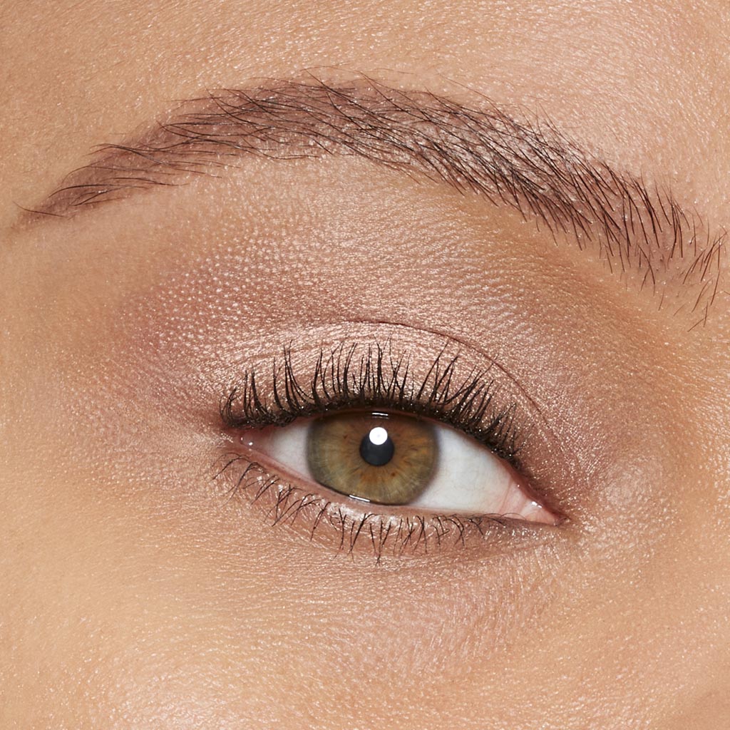 Model showcasing Eye Enhancer Eyeshadow Mono in 780 Rose Beam on eyelid.