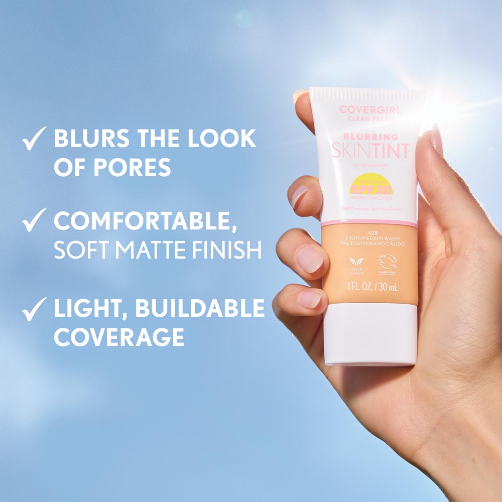 Model holding Covergirl Clean Fresh Blurring Skin Tint in shade 400 Fair Warm with SPF 30. BLURS THE LOOK OF PORES. COMFORTABLE, SOFT MATTE FINISH. LIGHT, BUILDABLE COVERAGE.