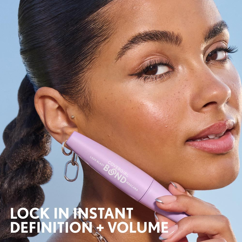 Model applying Lash Blast Bond Mascara in Extreme Black Waterproof. Lock in instant definition + volume.