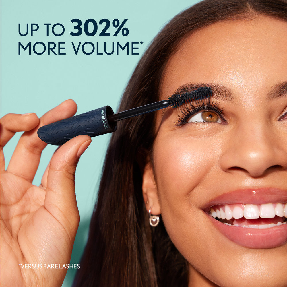 Model applying Lash Blast Cleantopia Mascara in Ultramarine Black, with text: Up to 302% more volume.