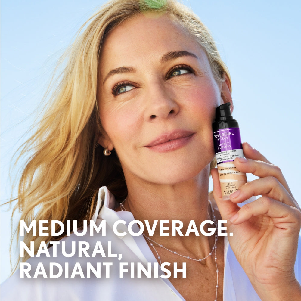 Woman holding bottle of CoverGirl + Olay Simply Ageless 3-in-1 foundation, medium coverage, natural finish.
