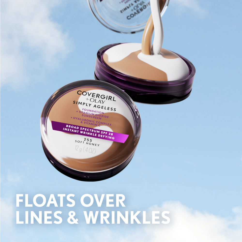 Covergirl + Olay Simply Ageless foundation in Soft Honey, 12g, with white and brown cream being poured out against a blue sky background.