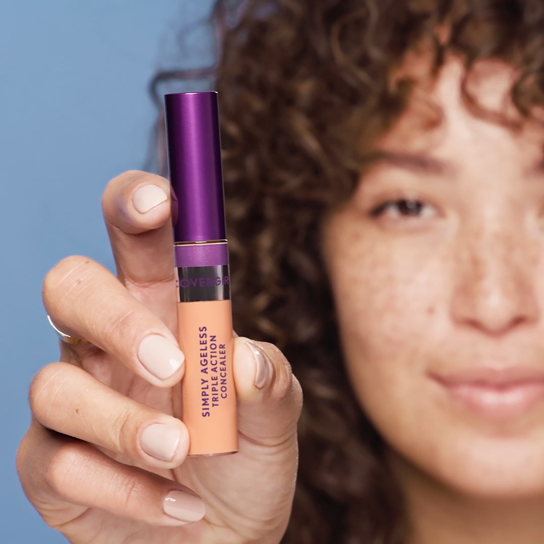 Model holding Covergirl Simply Ageless Triple Action Concealer.