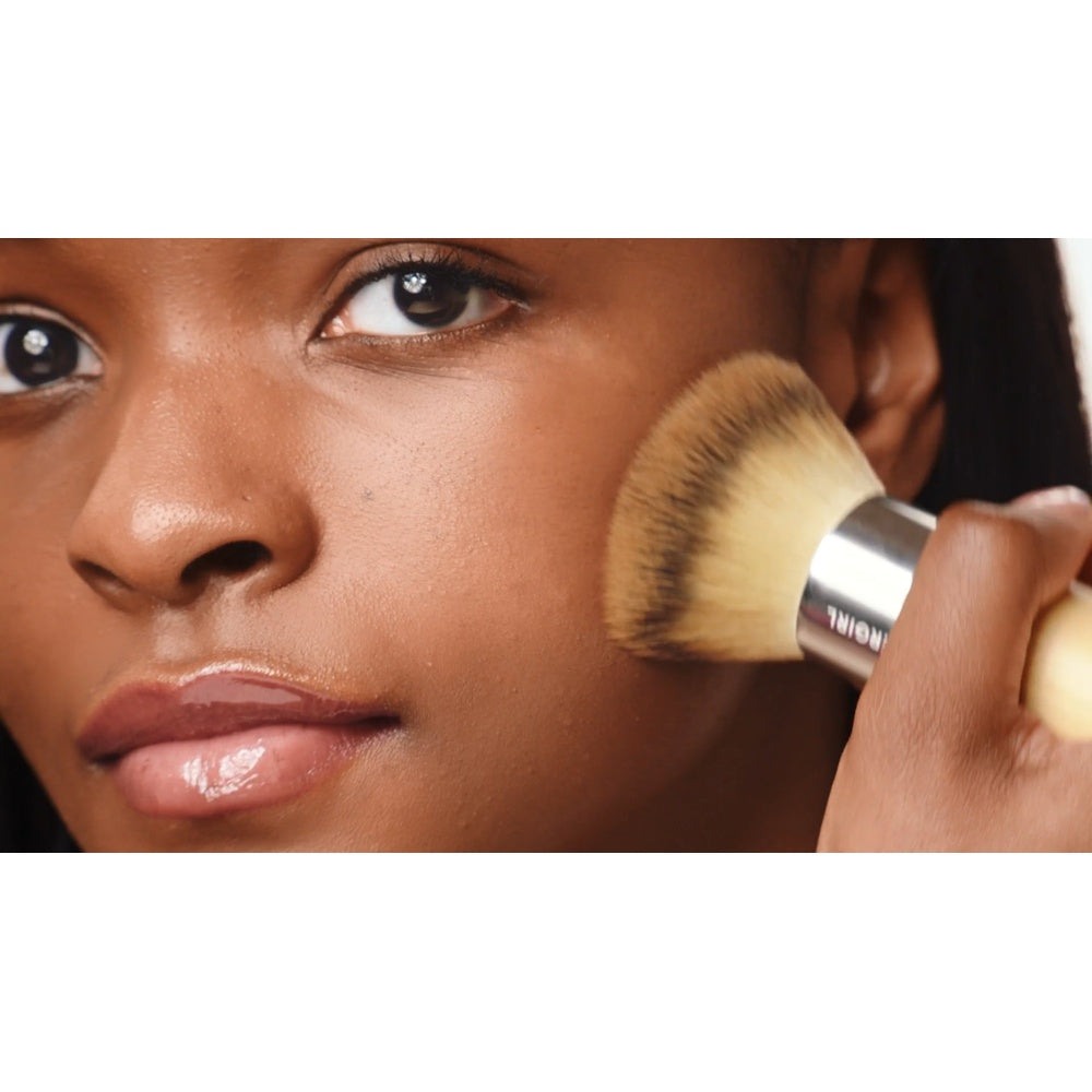 Model applying Blending Brush to the cheek.